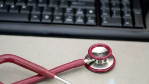 Stethoscope and keyboard representing Medicare routine foot care billing with the Q8 modifier