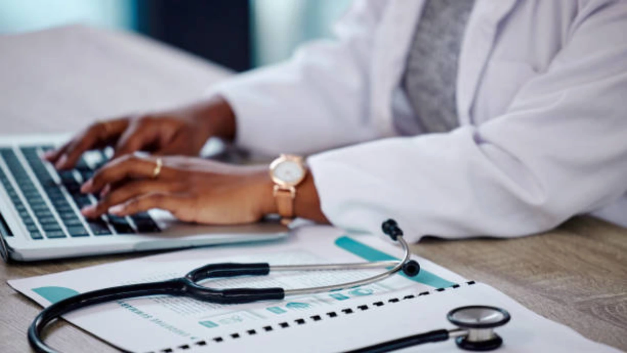Podiatry practice staff reviewing Medicare DMEPOS prior authorization paperwork for an ankle-foot orthosis