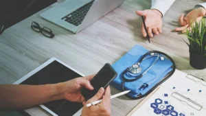 Podiatry billing staff reviewing a payer modifier 25 reimbursement policy bulletin